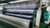 Full width interlining warp knitting machine
